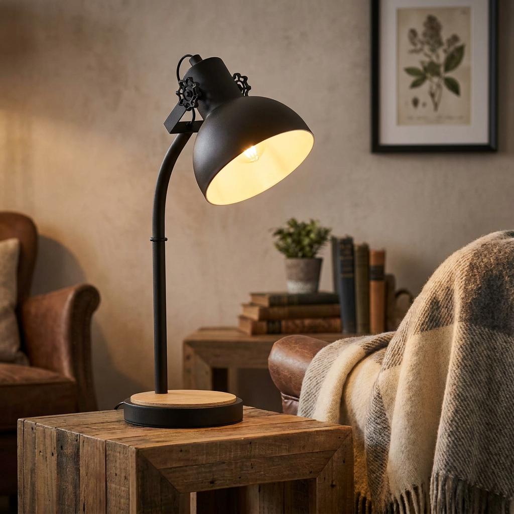Industrial black metal table lamp with a wooden base on a rustic side table in a cozy, warm-lit living room.