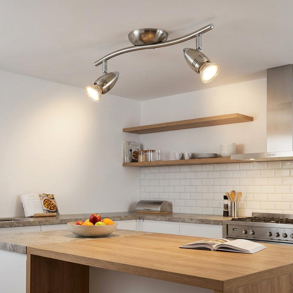 Eglo Magnum-LED nickel 2-light curved bar spotlight illuminated in a modern kitchen over a wooden island.