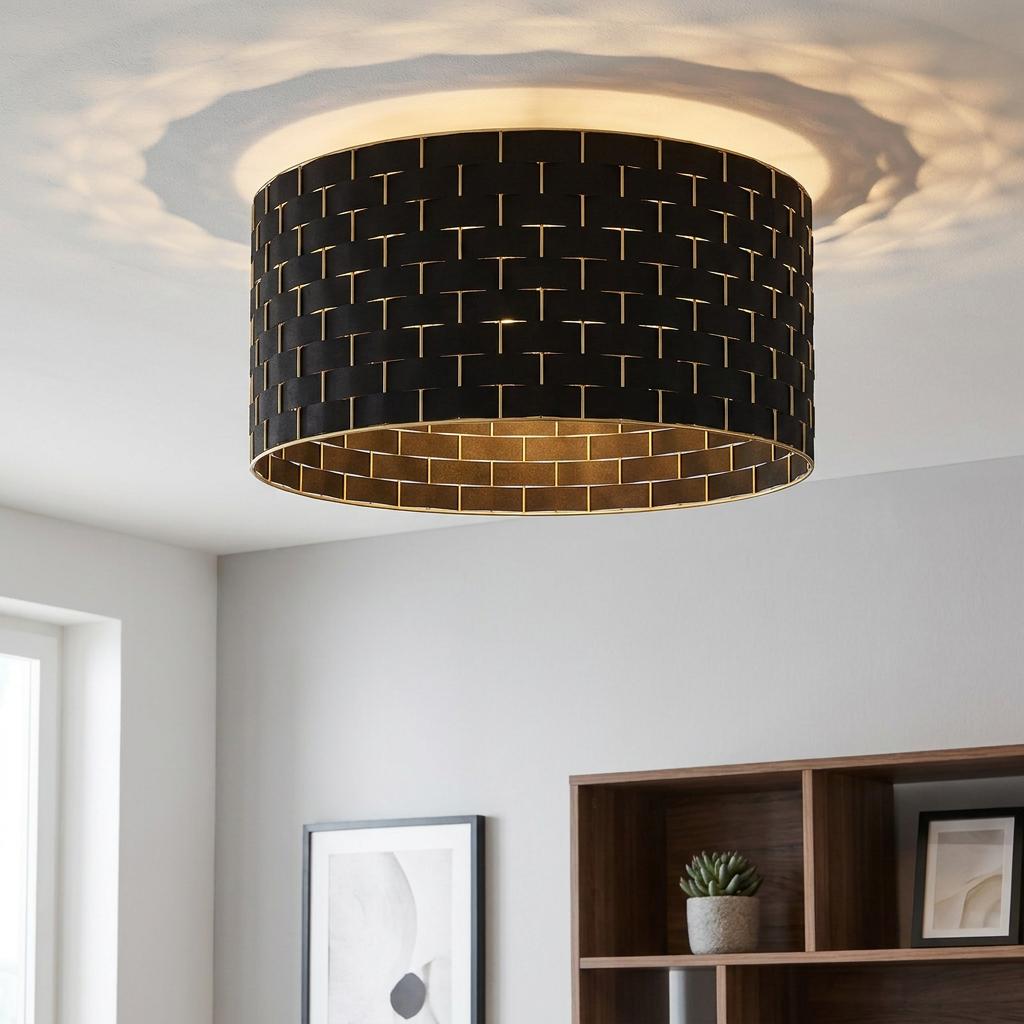 Round black fabric flush ceiling light with brass interior and a woven geometric pattern.