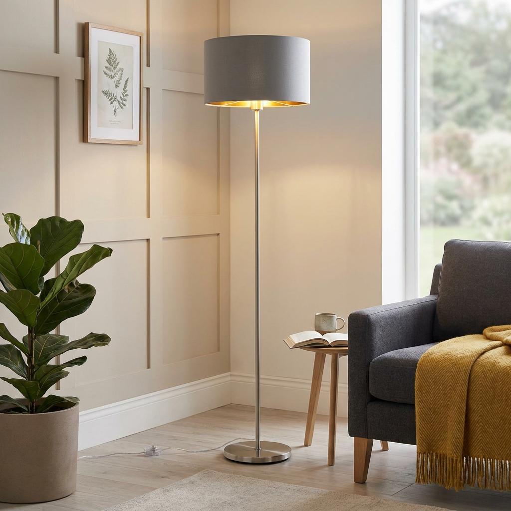 Modern floor lamp with a grey fabric shade and satin nickel base in a cozy living room setting.
