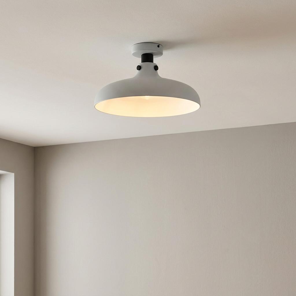 A light grey metal dome flush ceiling light mounted on a white ceiling in a neutral-toned room.