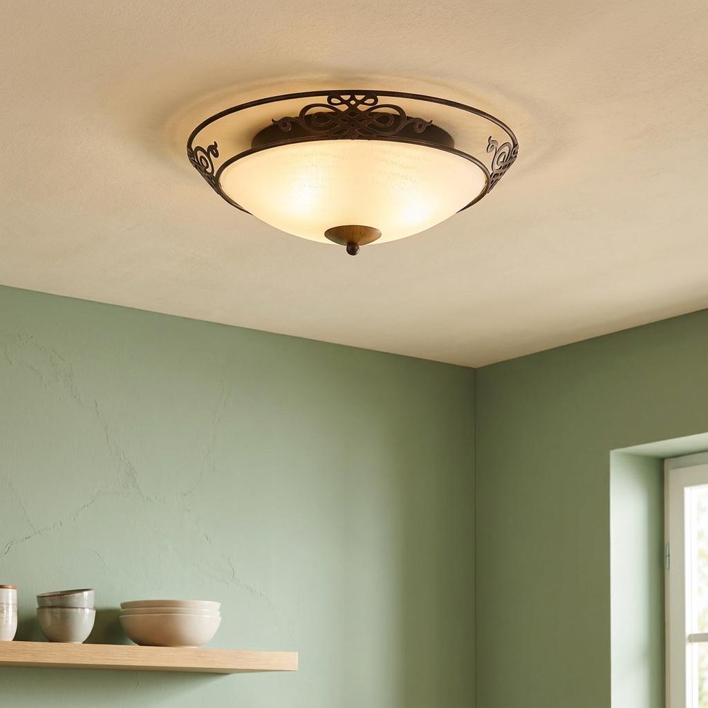 Eglo Mestre antique brown flush mount light with scrolled metal detail and beige glass bowl on a ceiling.