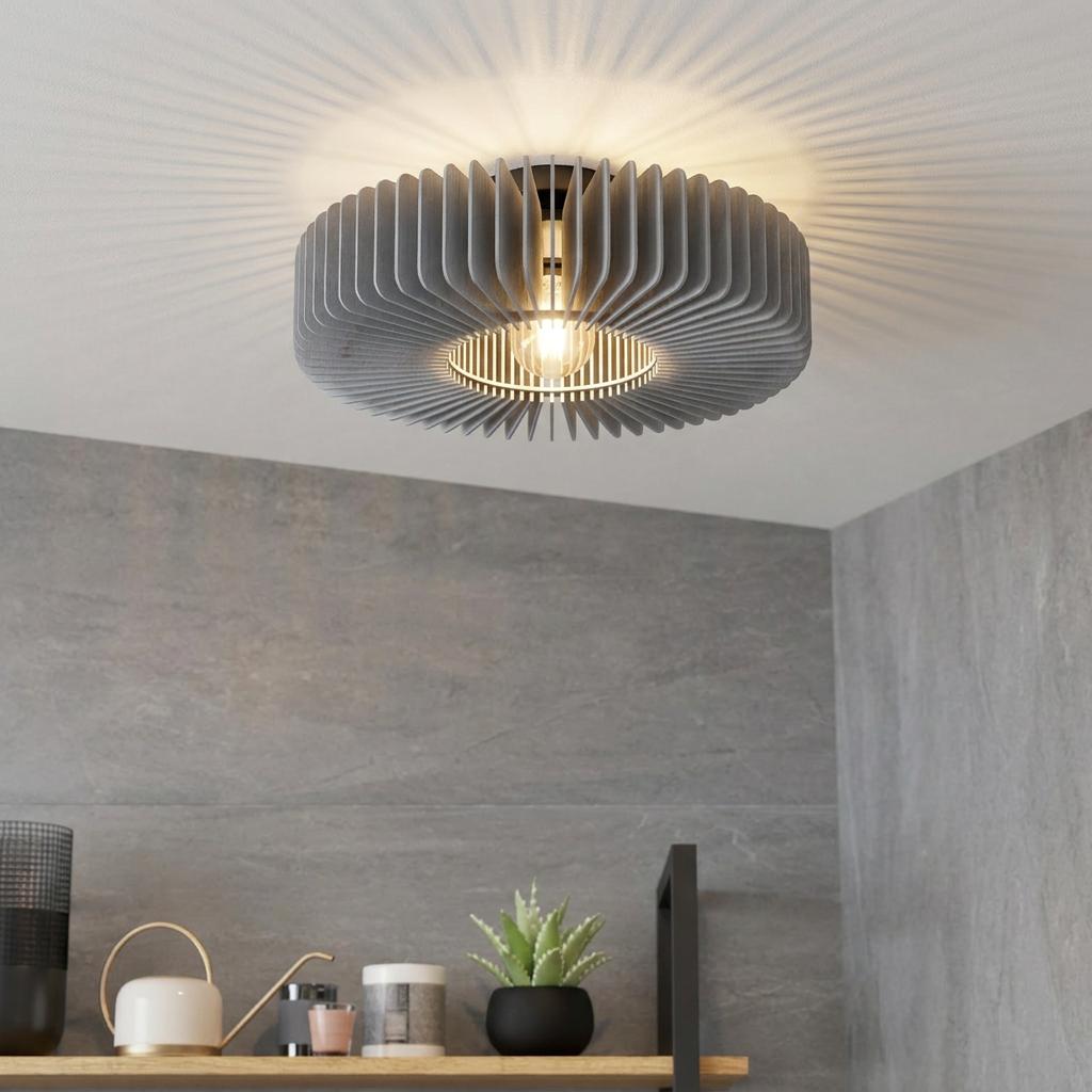 Modern grey slatted wooden ceiling light casting ray-like shadows in a room with grey stone walls.