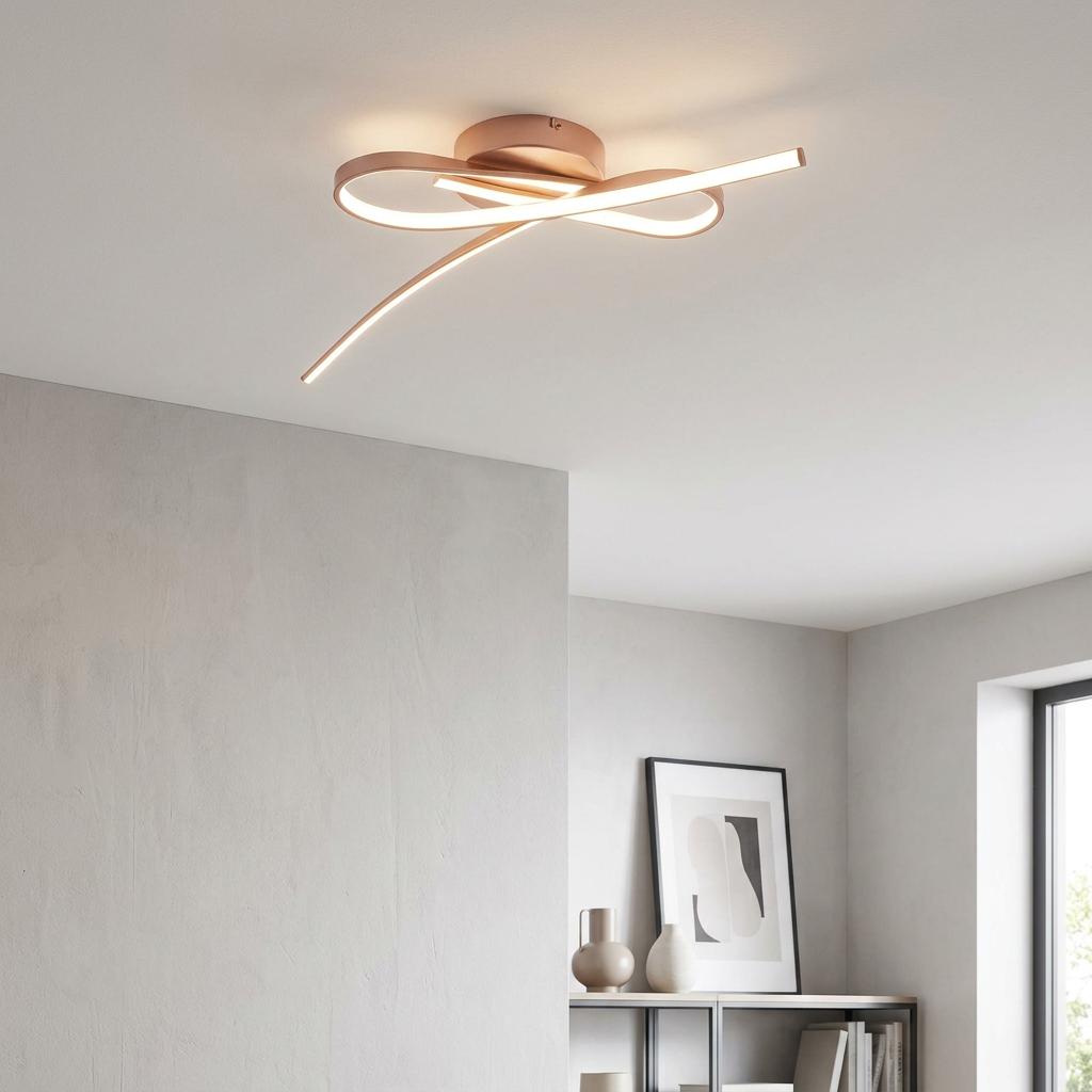 Sculptural rose gold LED flush ceiling light with curved strips in a minimalist interior.