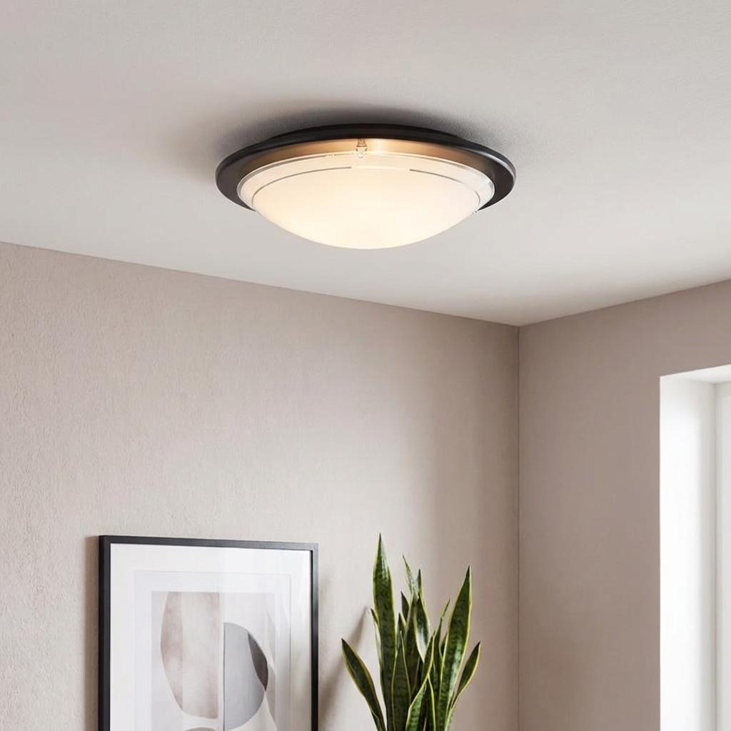 Eglo Planet 1 round black flush ceiling light with white frosted glass dome mounted on a neutral ceiling.