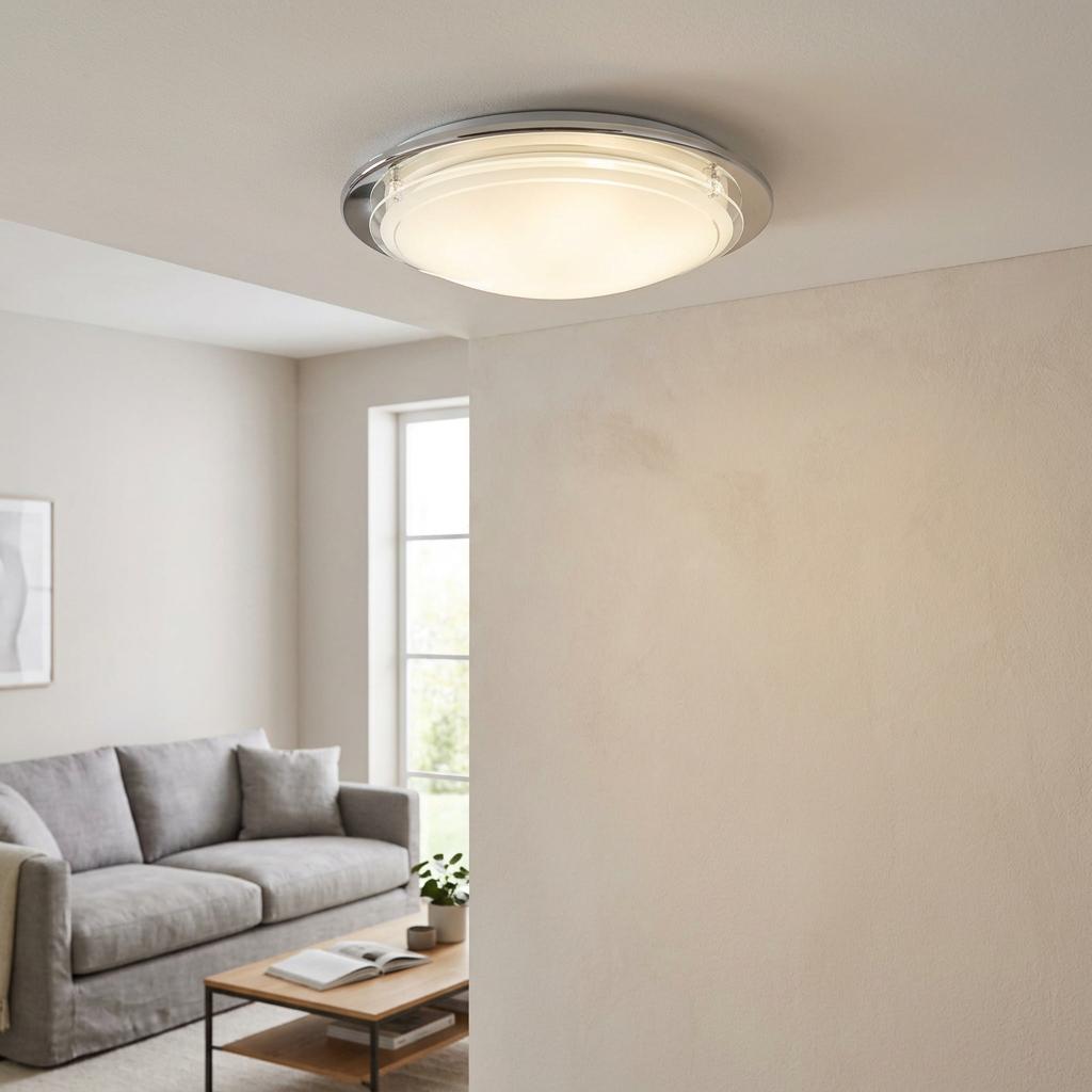Eglo Planet 1 round chrome flush ceiling light with frosted glass glowing in a modern living room.