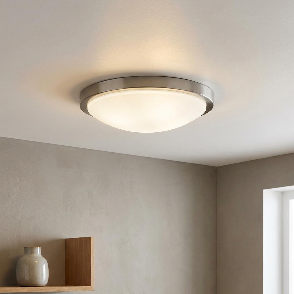 Eglo Planet flush ceiling light with a brushed nickel rim and white satin glass dome emitting a warm glow.
