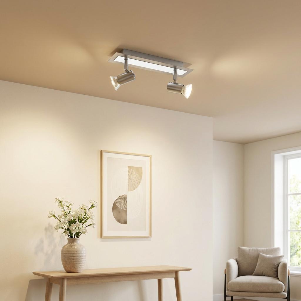 Modern nickel and chrome two-light bar spotlight ceiling fixture in a contemporary living room.
