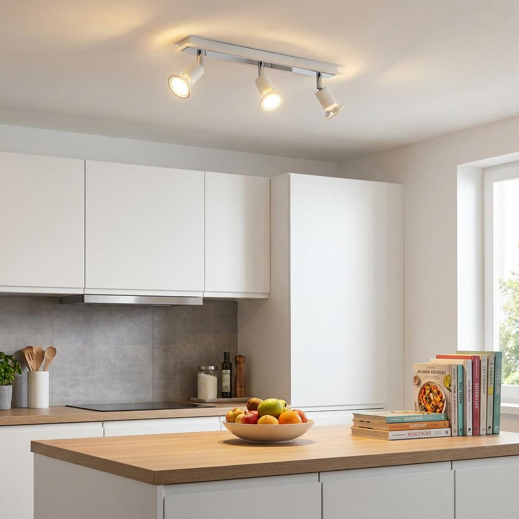 Eglo Sarria 3-light bar spotlight in white and chrome illuminating a modern kitchen space.
