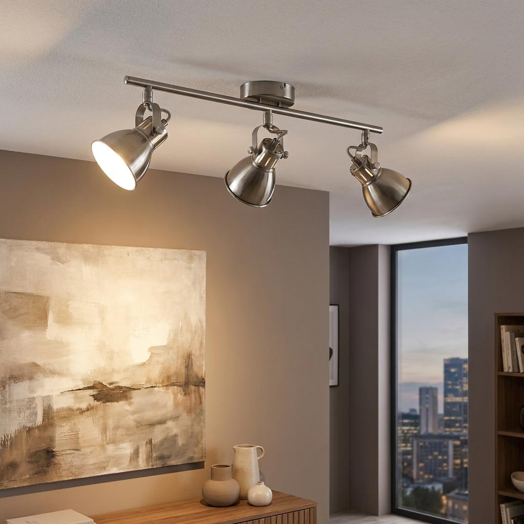 Eglo Seras brushed nickel 3-light bar spotlight on a ceiling, illuminating a modern living room interior.