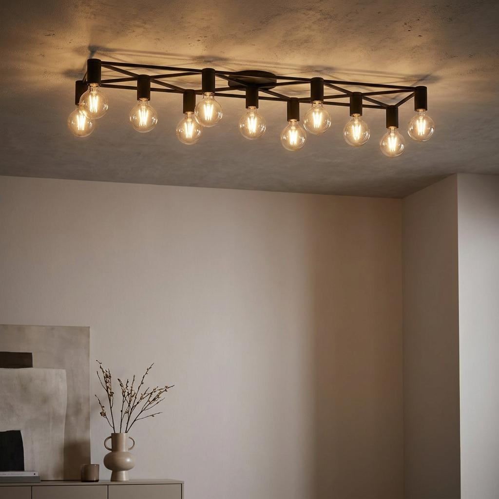 An Eglo Speke black 11-light flush ceiling light with exposed vintage-style bulbs on a grey ceiling.