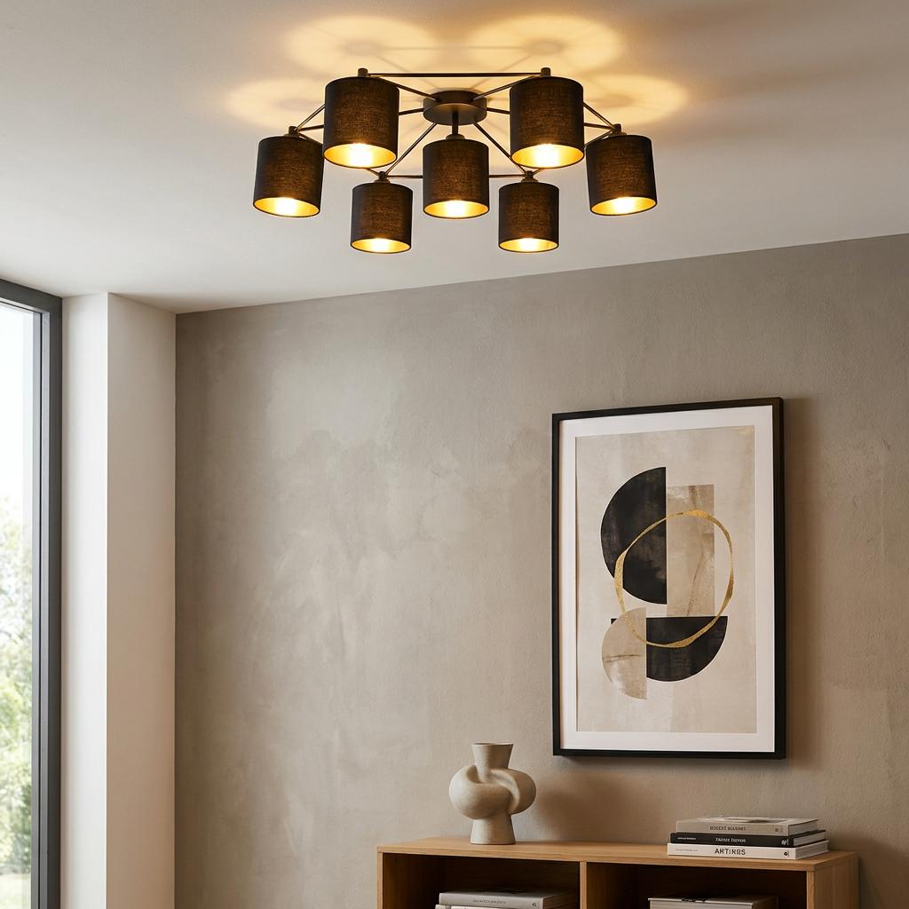 Modern Eglo Staiti 7-light flush ceiling fixture with black shades and gold glow in a minimalist room setting.