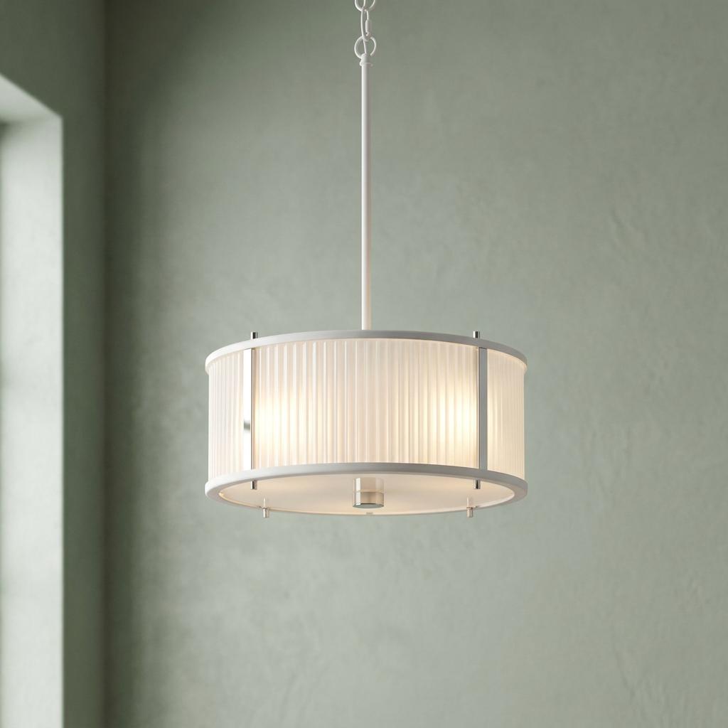 A three-light pendant with a white reeded glass shade and polished nickel frame hanging against a sage green wall.