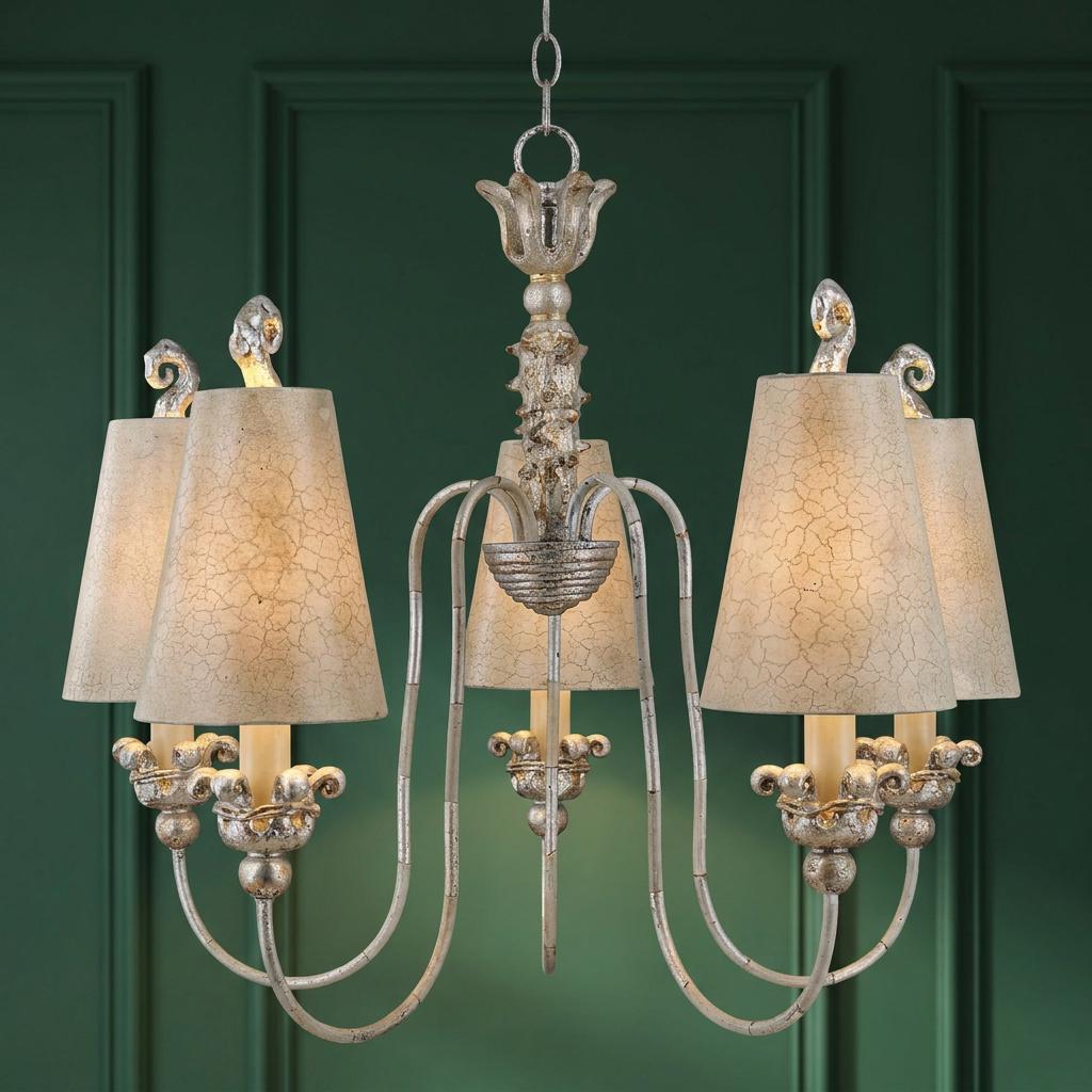 Silver 5-light chandelier with crackle-effect shades and ornate scrolling arms against a dark green paneled wall.