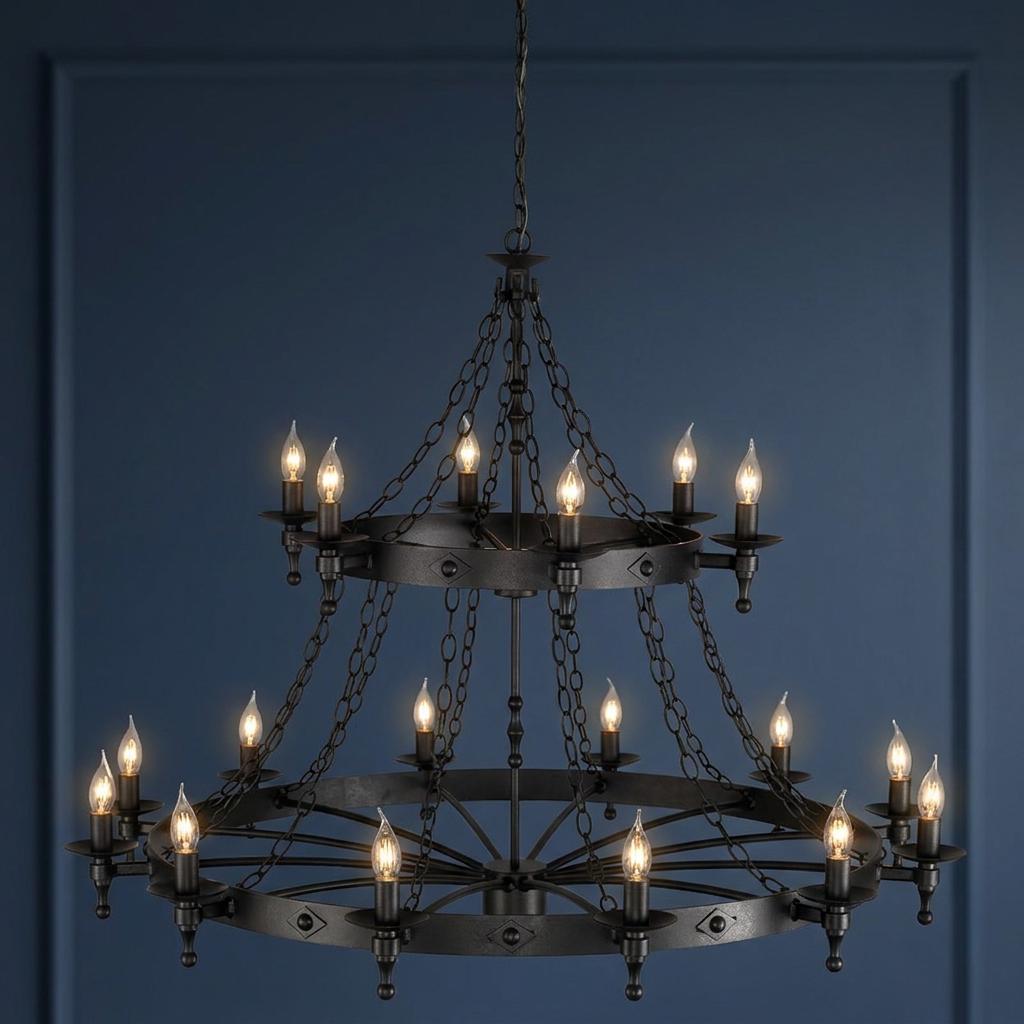 Two-tier Warwick 18-light graphite chandelier with medieval style candle bulbs against a dark blue paneled wall.