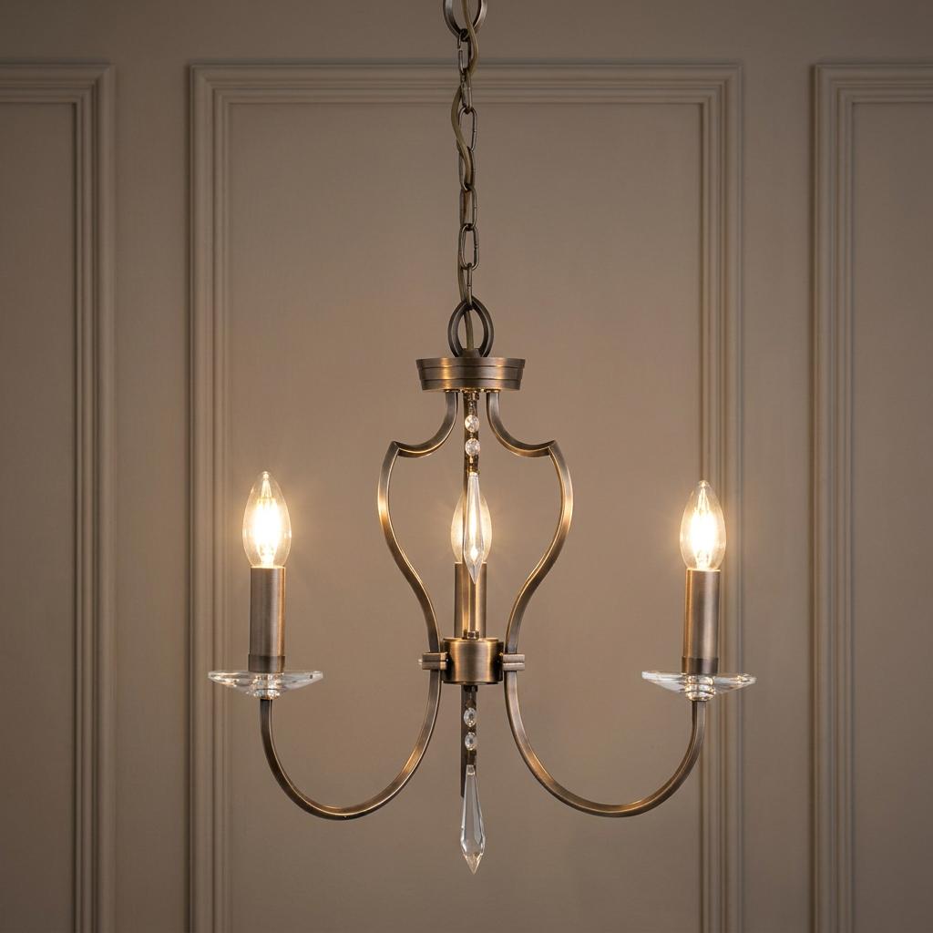 Elstead Pimlico three-light dark bronze chandelier with crystal accents and candle-style bulbs against a paneled wall.