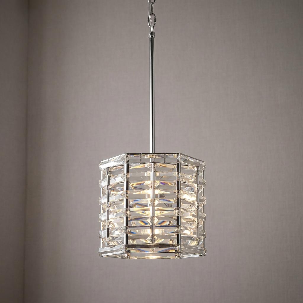 Polished nickel pendant light with horizontal crystal prisms in an octagonal cage, glowing softly.