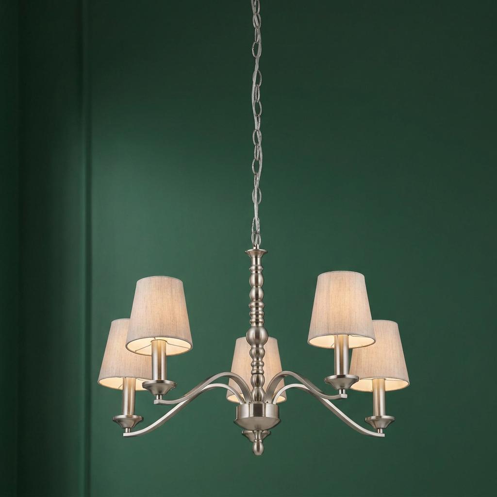Satin nickel 5-arm chandelier with cotton shades hanging against a deep green wall.