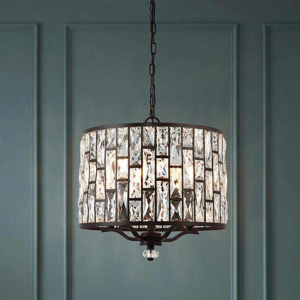 Five-light drum pendant with rectangular clear crystals in a bronze frame against a teal paneled wall.