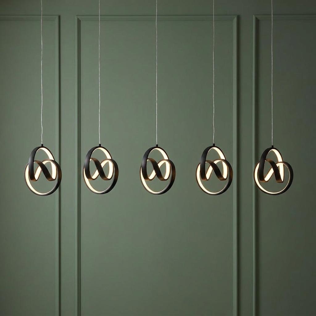Five black circular LED pendant lights hung in a row against a sage green paneled wall.
