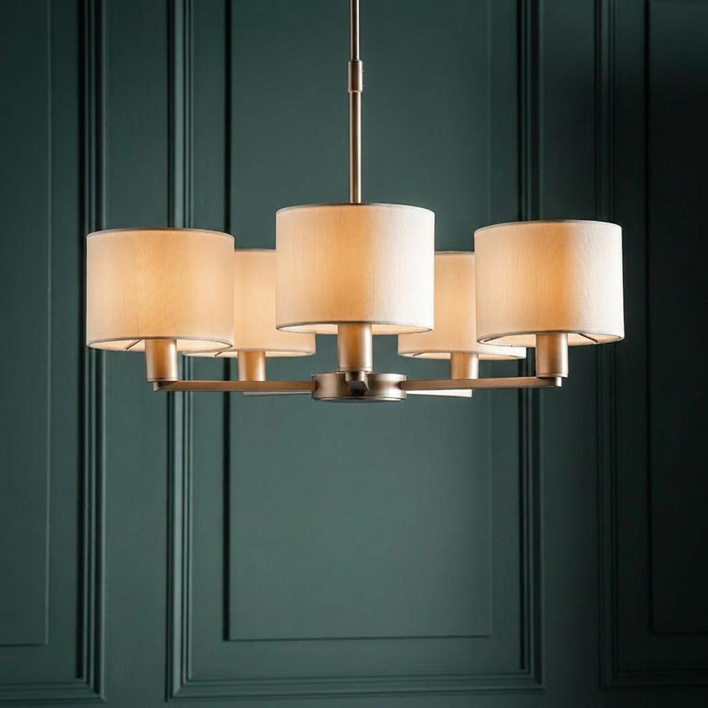 Endon Daley 5-light nickel ceiling pendant with glowing fabric drum shades against a dark green paneled wall.