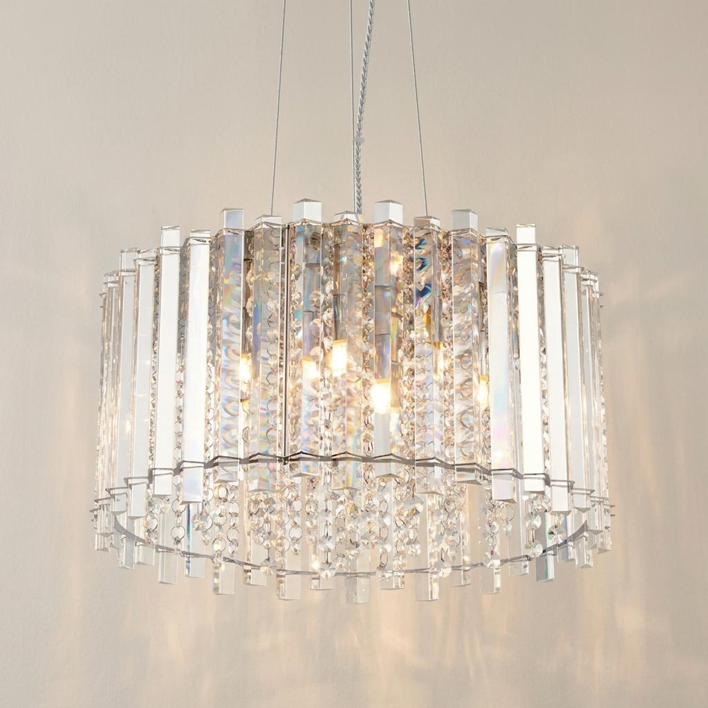 Elegant 5-light polished chrome pendant featuring vertical crystal glass prisms and shimmering internal droplets.
