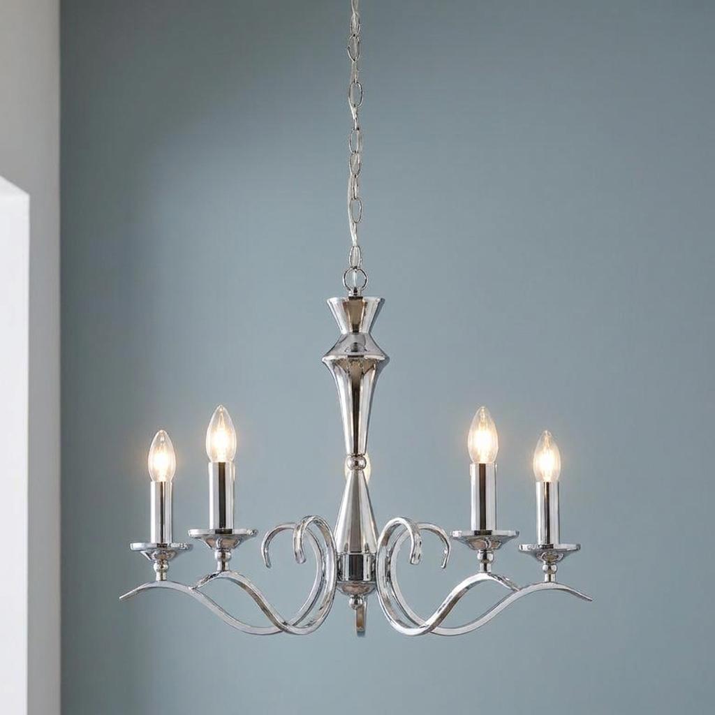 Chrome finish 5-light chandelier with curved arms and lit candle-style bulbs against a blue wall.