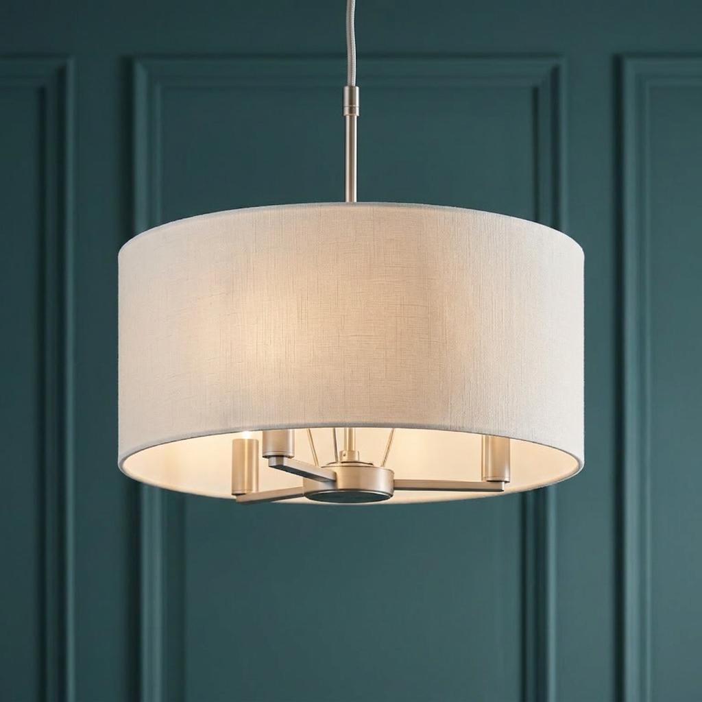 Endon Lighting Daley 3-light matt nickel pendant with a cream fabric drum shade against a dark teal paneled wall.