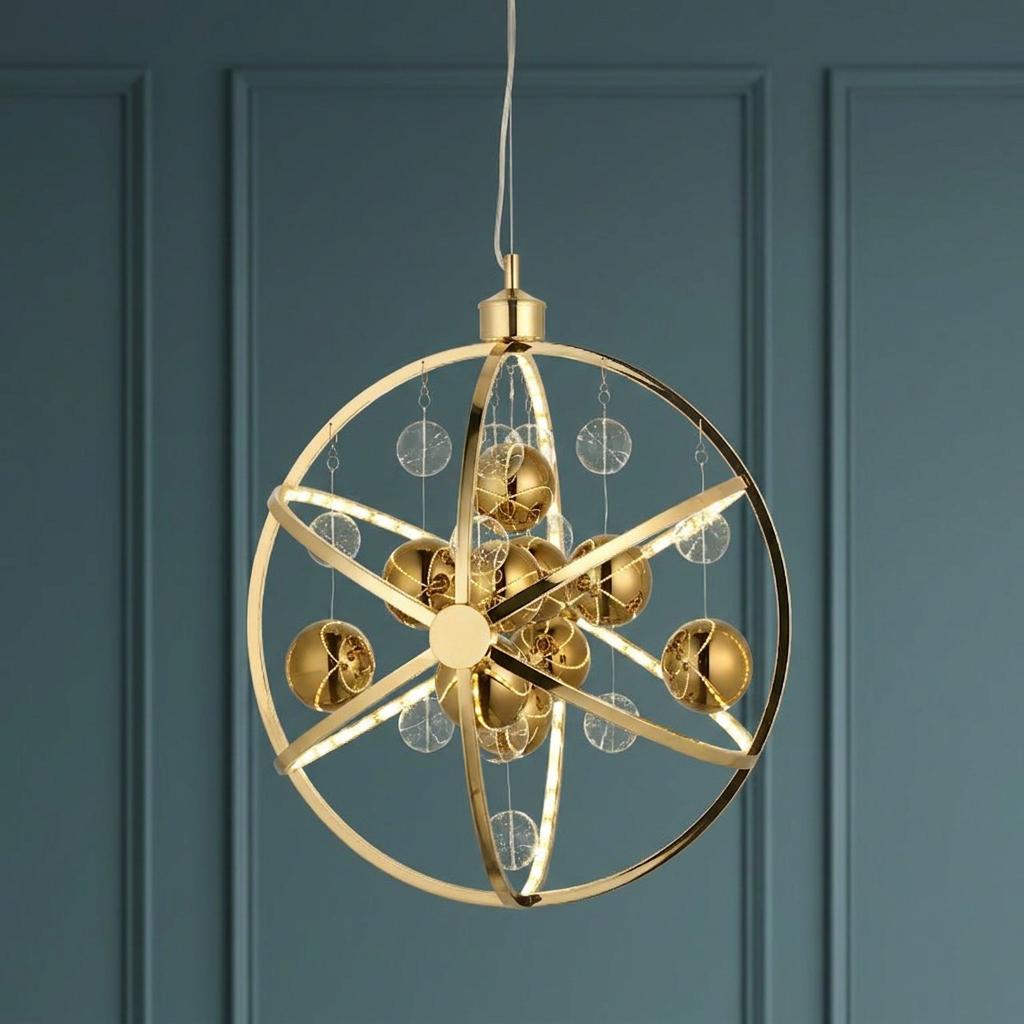 Gold orbital LED ceiling pendant with hanging clear discs and gold spheres against a blue paneled wall.