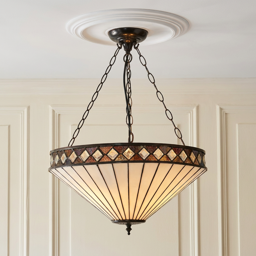 Inverted Art Deco Tiffany pendant light with cream glass and diamond patterned rim, suspended by chains.