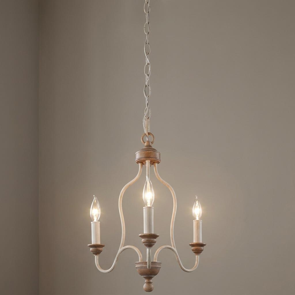 Three-light chandelier with chalk washed beechwood accents and curved off-white arms hanging against a neutral wall.