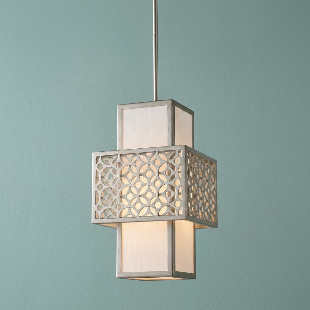 Silver mini-pendant light with geometric fretwork and white shade, glowing against a teal background.