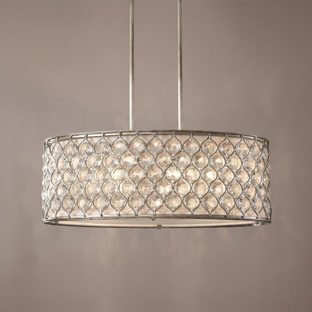 Silver oval pendant light featuring a crystal-studded lattice shade against a neutral wall.
