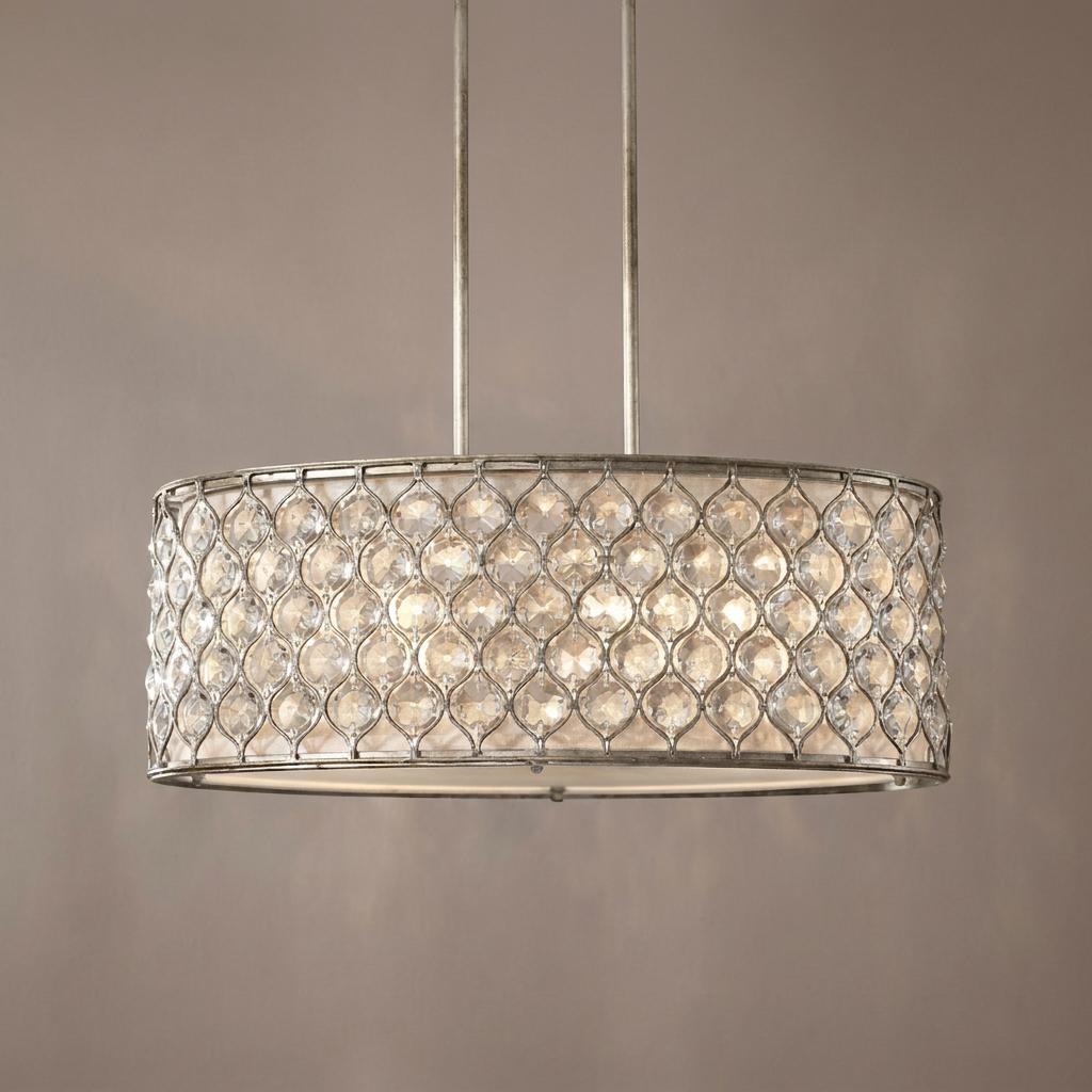 Silver-leaf drum pendant light with an intricate crystal lattice pattern and a warm interior glow.