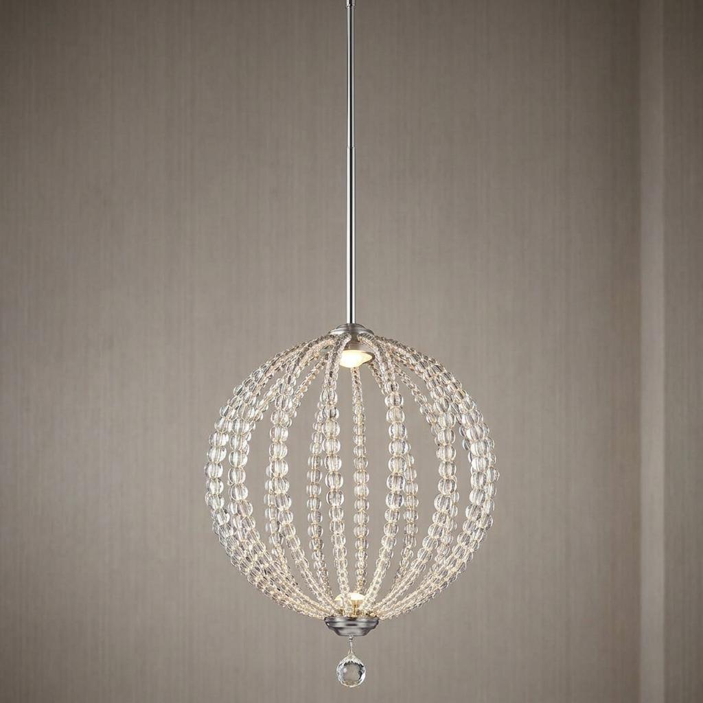 Satin nickel LED pendant light with a spherical frame draped in clear glass beads against a neutral textured wall.