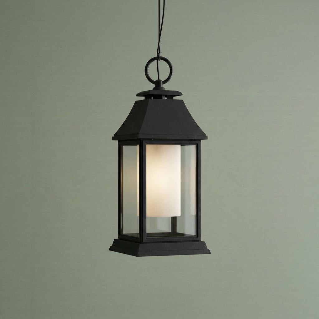 Classic black outdoor lantern pendant featuring clear outer glass and a frosted white inner diffuser.