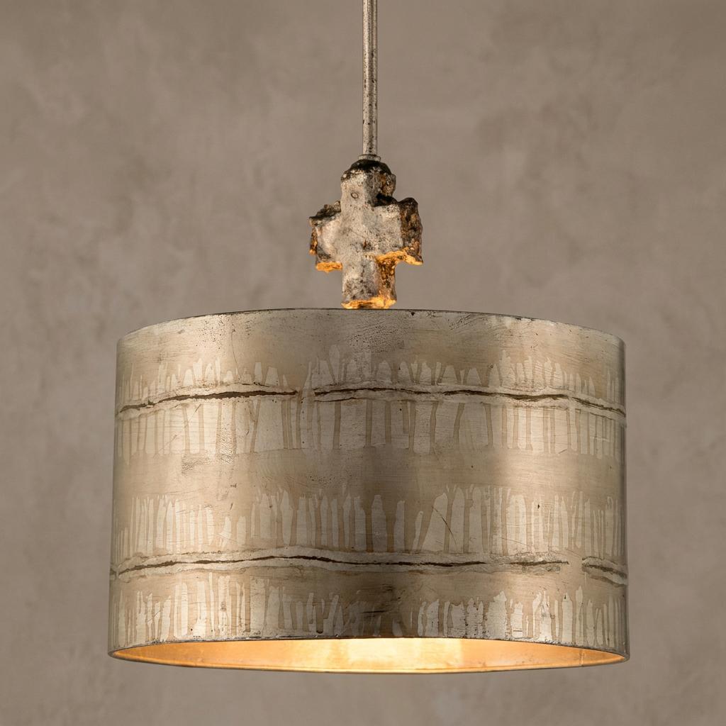 Large silver pendant light with an etched drum shade and a distressed cross detail at the top.