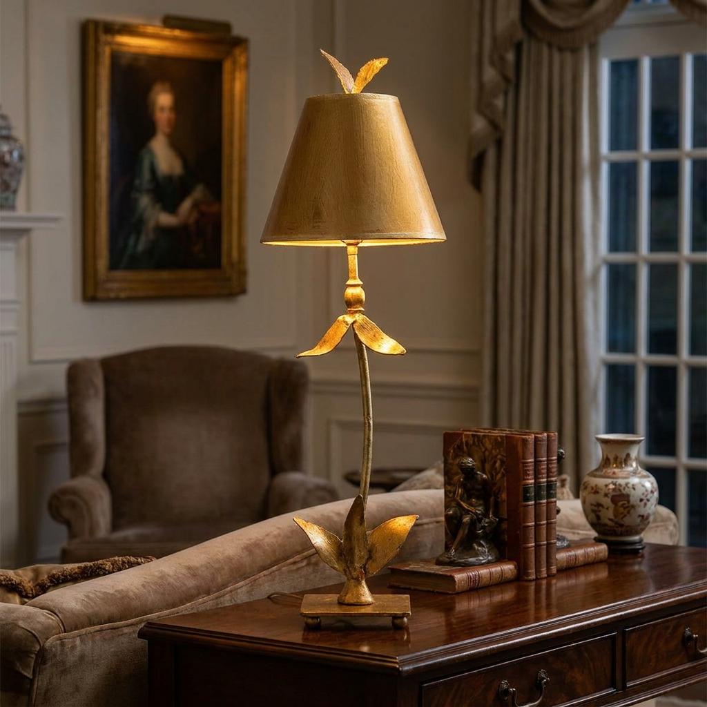 Gold leaf floral table lamp on a wooden console table in a classic living room setting.