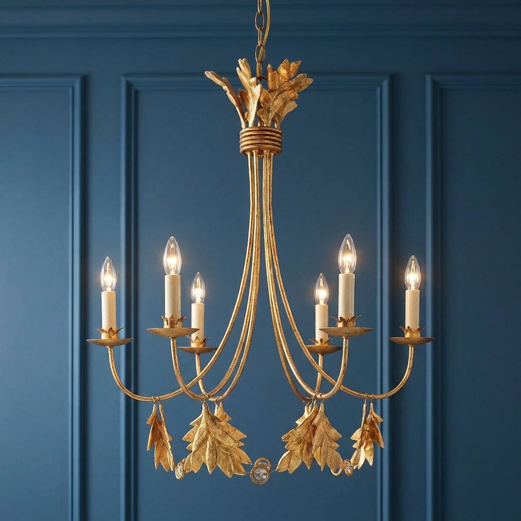 Flambeau Sweet Olive 6-light gold chandelier with hanging leaf accents against a blue paneled wall.