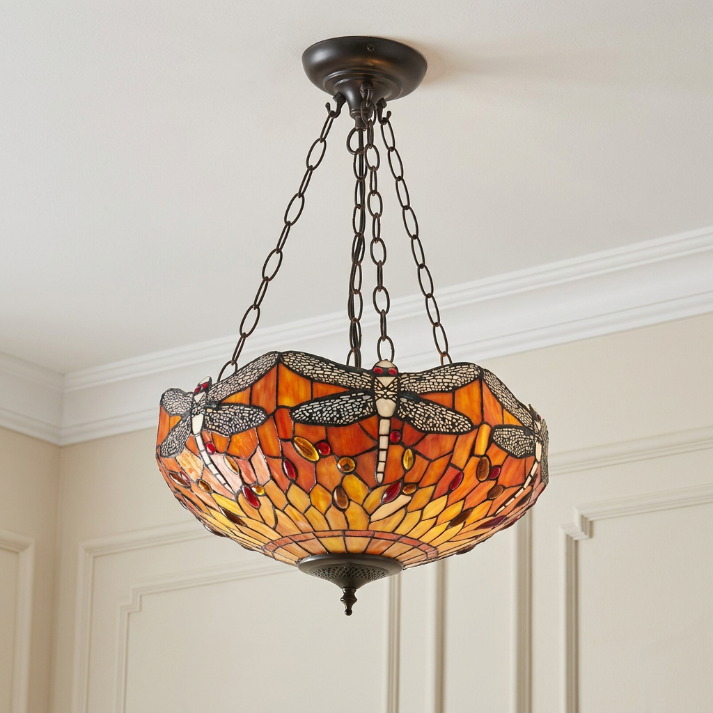 Flame Dragonfly inverted Tiffany pendant light with vibrant orange stained glass and dragonfly motifs on a ceiling.