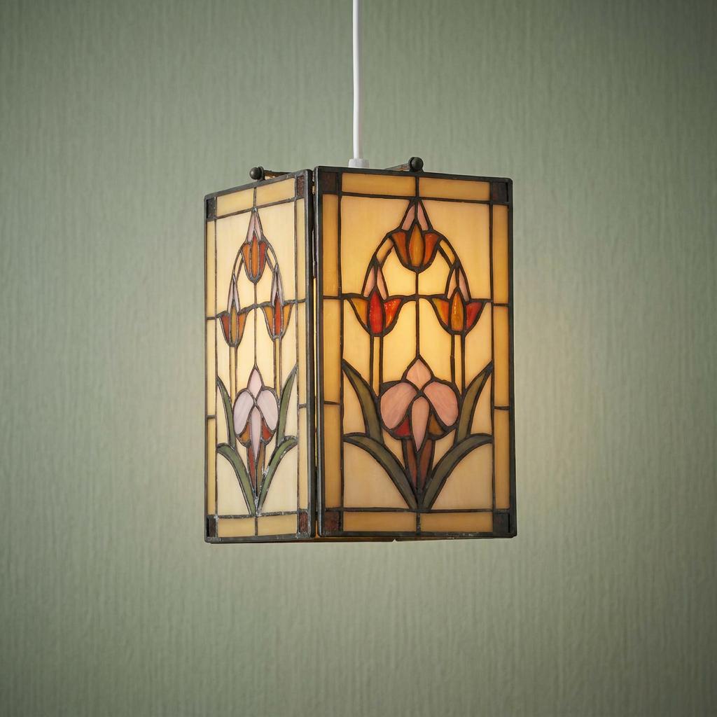 Rectangular Tiffany-style stained glass pendant lamp shade with floral patterns hanging against a green wall.