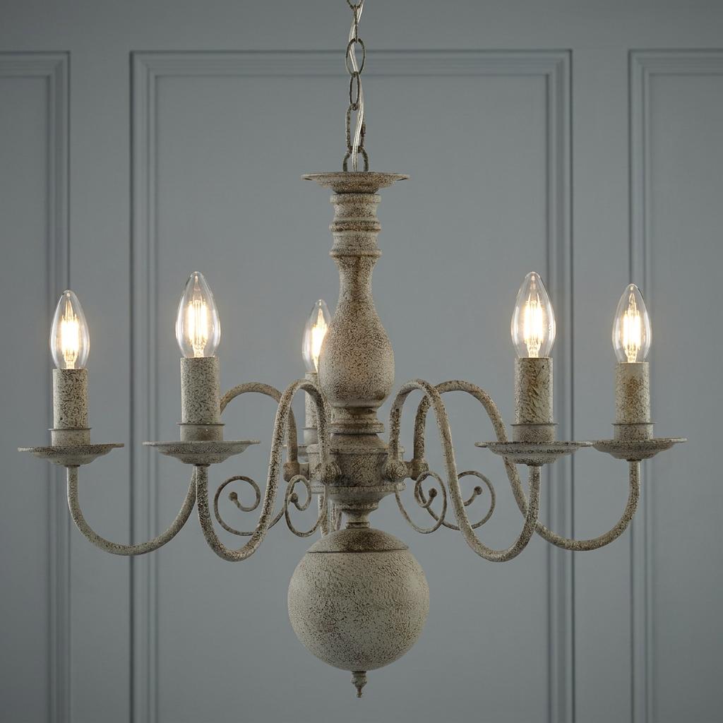 A Greythorne 5-light textured grey chandelier with a rustic finish and candle-style bulbs against a paneled wall.