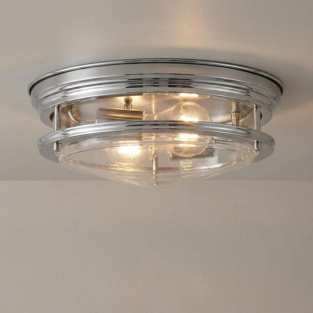 Hadrian chrome and clear glass 2-light flush mount ceiling fixture illuminated on a white ceiling.