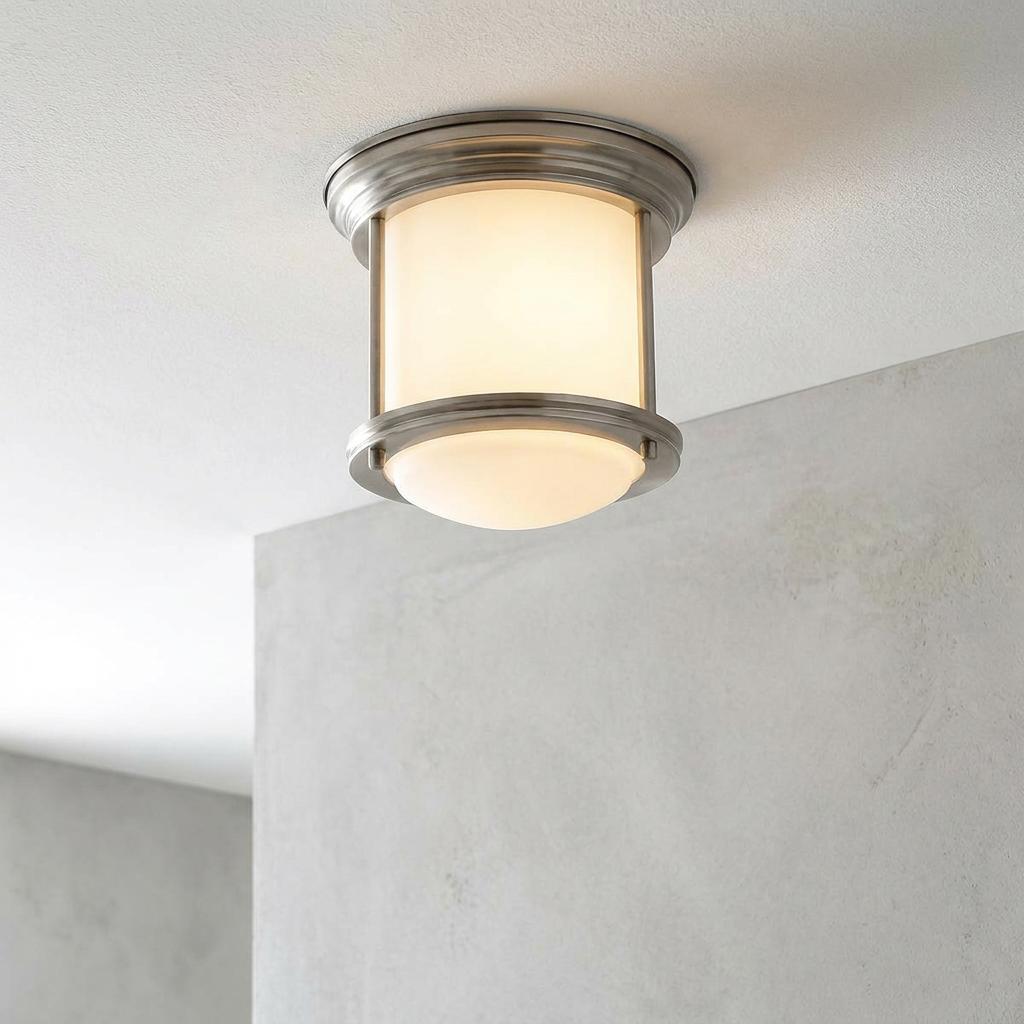 Hadrian flush bathroom ceiling light with opal glass and antique nickel frame mounted on a white ceiling.