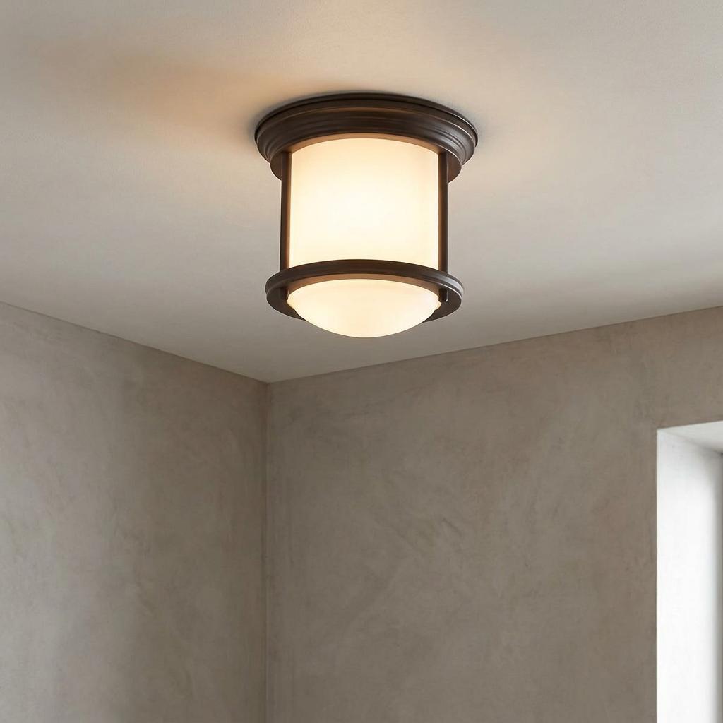 Hadrian flush ceiling light with opal glass and oil-rubbed bronze frame mounted on a white ceiling.