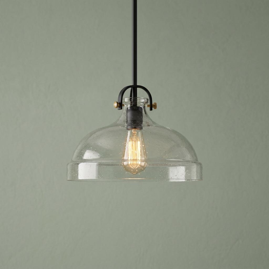 Hampton pendant light with a graphite stem and seeded glass dome shade against a sage green wall.