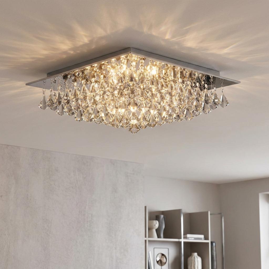Square chrome ceiling light with pyramid crystal droplets casting warm light in a modern room.