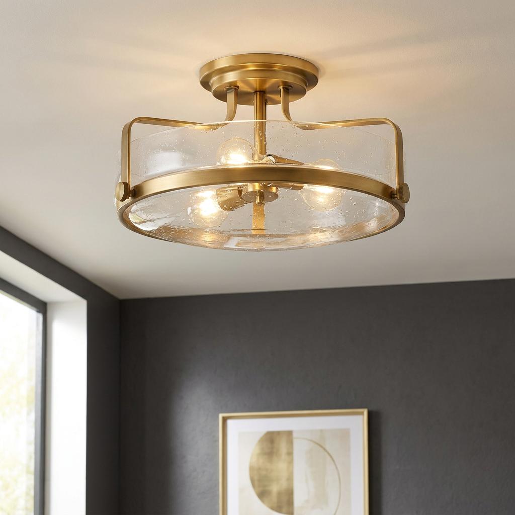 Harper 3 Light Brass Medium Semi-Flush Ceiling Light with three glowing bulbs and a seeded glass shade.