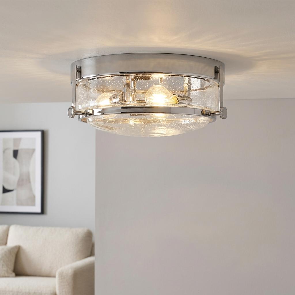 A Harper three-light polished chrome flush ceiling light with seeded glass shade illuminated in a living room.