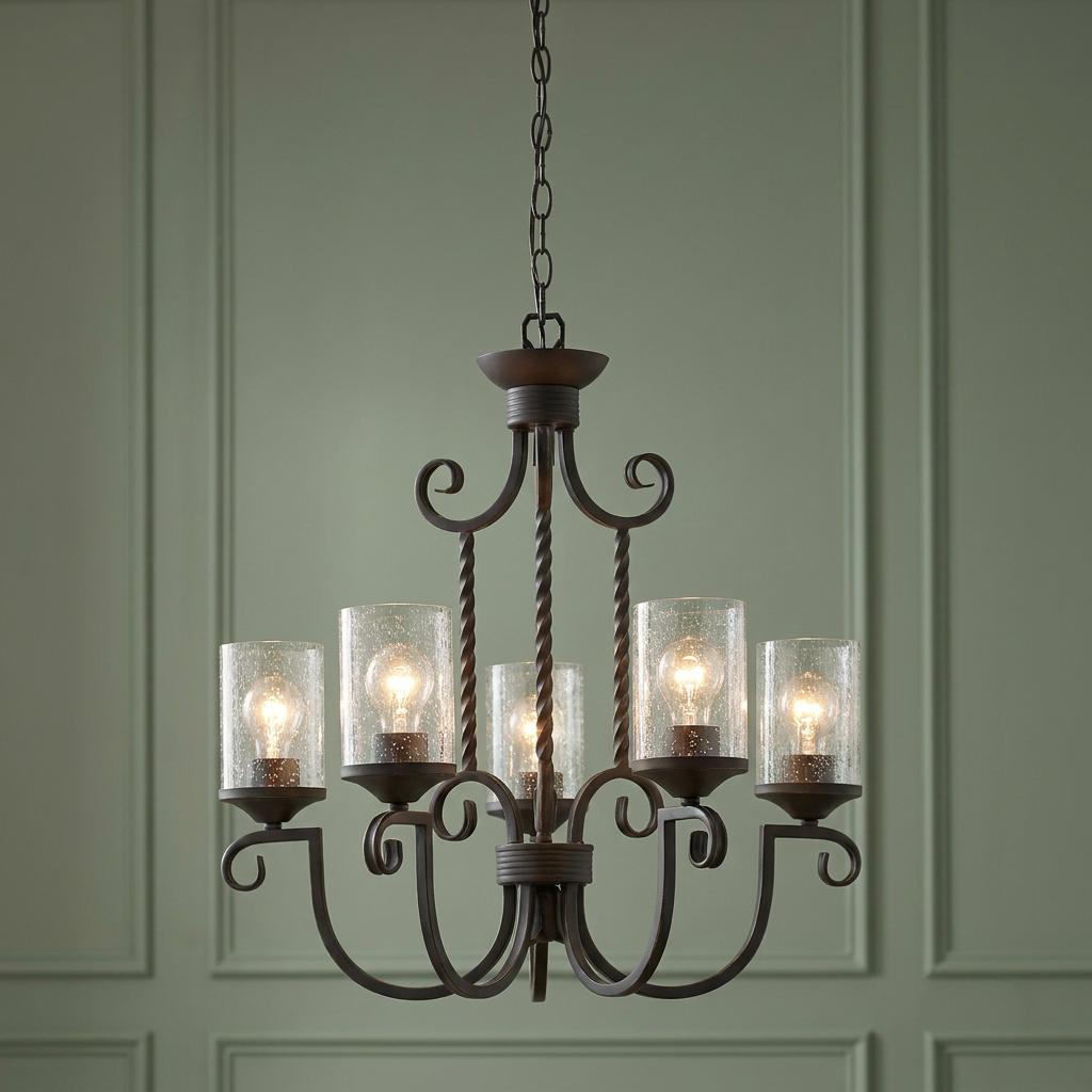 Hinkley Casa 5-light chandelier in dark bronze with clear seeded glass shades against a green paneled wall.